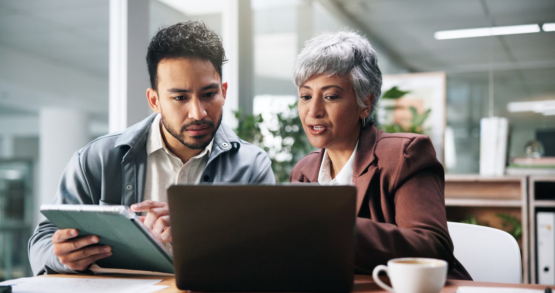 A team collaborating with a tablet and laptop